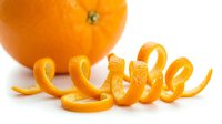 Fresh orange with curled citrus peel zest on white background, isolated for food, cooking, and healthy lifestyle design use.