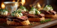 Grilled beef steak slices on toasted bread with herb butter and microgreens served as gourmet appetizers on wooden board for fine dining restaurant menu.