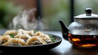 Steaming dumplings served on a dark plate with traditional teapot, ready for meal preparation, cooking content, and food styling projects.
