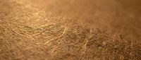 Close-up macro view of brown leather texture showing natural grain patterns and surface details for luxury fashion and craftsmanship projects.
