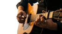 Musician with dark skin playing acoustic guitar against white background, suitable for music education, performance promotion, and entertainment content.