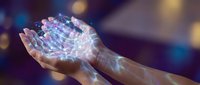 Hands holding glowing digital network mesh with light particles, representing technology, connectivity, data transfer, and innovation in business and communication.