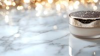 Luxurious cosmetic cream jar on marble surface with golden bokeh lights background creates elegant beauty product presentation atmosphere.