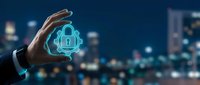 Businessman hand protecting glowing cloud security lock icon against blurred city night background representing cybersecurity and data protection services.