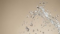 Clear water splash with droplets frozen in motion against neutral beige background for refreshing beverage and hydration concepts.