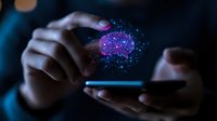 Digital brain hologram floating over smartphone with neural connections and glowing particles, hands holding mobile device in dark ambient lighting.