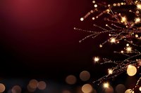 Elegant golden Christmas tree branch with sparkling lights and ornaments on dark red background with bokeh effects for holiday greeting cards.