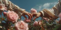 Young couple holding hands over blooming pink roses in garden with blue sky background symbolizing love romance and connection in nature setting.