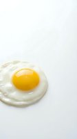 Fresh fried egg with golden yolk isolated on white background for breakfast menu design and culinary projects.