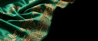 Luxurious emerald green silk fabric with intricate golden paisley embroidery draped elegantly against dark background for premium textile design projects.