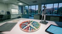 Modern laboratory workspace with colorful sample wheel display and digital equipment for scientific research and analysis.