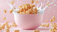 Popcorn kernels splashing with milk in pink ceramic bowl against pastel background, dynamic food photography capturing motion and texture in soft lighting.