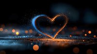 Glowing heart shape created from blue and orange light particles against dark background with bokeh effects and reflective surface.