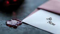 Elegant burgundy wax seal on romantic love letter with calligraphy text, perfect for wedding invitations and Valentine's Day greeting cards.