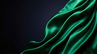 Luxurious emerald green silk fabric with flowing waves and elegant folds against dark background for premium design projects and sophisticated branding.