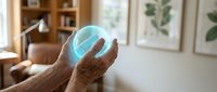 Hands holding glowing blue holographic sphere in modern home office representing digital technology, innovation and futuristic concepts for business presentations.