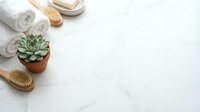 Spa wellness setup with towels, wooden brushes, succulent plant and natural accessories on white marble surface for relaxation and self-care routine.