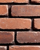 Close-up view of red brick wall showing detailed texture and mortar joints, creating classic architectural pattern suitable for construction and design backgrounds.