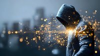 Mysterious hooded figure with glowing golden light particles against urban skyline background, creating dramatic atmosphere for cybersecurity or technology concepts.