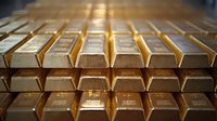 Stacked gold bars with selective focus creating depth perspective, showcasing precious metal investment and wealth concept in warm lighting.