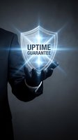 Businessman hand presenting glowing uptime guarantee shield symbol with bright light rays for technology reliability and service assurance concepts.