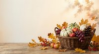 Autumn harvest basket with pumpkins, apples and colorful fall leaves on wooden table with warm seasonal lighting for thanksgiving decoration.