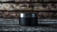 Black cosmetic jar with metallic lid on dark wooden surface, minimalist luxury skincare packaging mockup for beauty product branding and design presentation.
