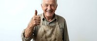 Senior male craftsman with gray hair and mustache, wearing tan work apron, giving thumbs up gesture against white background. Suitable for trades, construction, and professional services marketing.