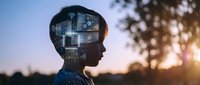 Young man silhouette with digital brain circuit overlay at sunset representing artificial intelligence, machine learning and futuristic technology concepts.