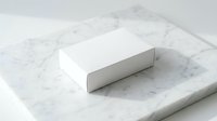 White rectangular cardboard box mockup on marble surface for product packaging design and branding presentations.