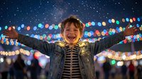 Happy young boy with arms outstretched celebrating under colorful festive lights at night. Joyful child expressing freedom and excitement during holiday celebration.