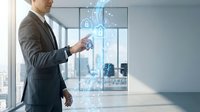 Professional businessman in suit interacting with holographic cybersecurity interface displaying digital locks and data protection symbols in modern office.