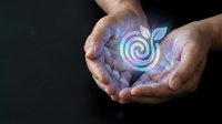 Cupped hands holding glowing spiral energy symbol with ethereal light effects on dark background for wellness and spiritual healing concepts.