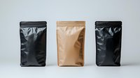 Three coffee bags in black and kraft paper standing in row on light background, mockup for branding and packaging design presentation.