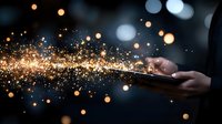 Magical glowing sparkles and light particles flowing from smartphone screen held in dark, creating ethereal atmosphere. For fantasy or technology concepts.