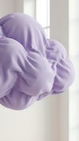 Soft lavender purple fabric flowing gracefully in natural window light creating elegant textile waves and folds for fashion design projects.