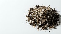Organic vermiculite mineral aggregate pile isolated on white background for gardening soil amendment and horticultural applications.