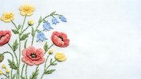 Delicate floral embroidery with poppies, daisies and bluebells on white fabric. Handcrafted needlework design for textile decoration and crafting projects.