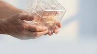 Hands holding glowing digital cube with circuit patterns representing technology innovation and futuristic computing concepts for business presentations.