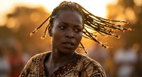 Young African woman with traditional dreadlocks hairstyle in warm golden sunset light, cultural portrait showcasing natural beauty and ethnic heritage.