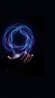 Human hands holding glowing blue purple energy sphere with swirling light trails on dark background for technology and magic concepts.