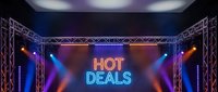Hot deals neon sign on concert stage with colorful lighting and metal truss framework for promotional marketing campaigns and sales events.