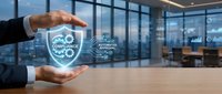 Business professional hands protecting compliance shield with regulatory approval icons in modern corporate office environment.