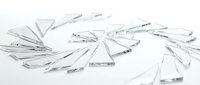 Broken glass shards scattered on white surface, isolated fragments for design projects, backgrounds, and creative compositions.