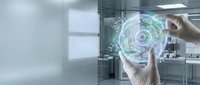 Hands holding glowing digital hologram with circular data visualization in modern office environment, representing technology innovation and futuristic business solutions.