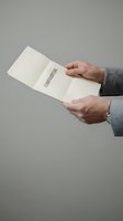 Professional businessman hands holding confidential document folder in corporate office setting for business communication and data protection.