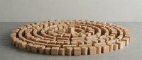 Wooden blocks arranged in circular maze pattern on neutral background. Natural wood construction toy for educational play and problem-solving activities.