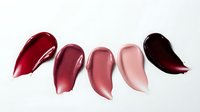 Lipstick swatches in various shades from deep red to burgundy on white background. Cosmetic color palette for makeup and beauty applications.