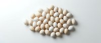Pile of white soybeans scattered on clean white background, isolated organic legumes for healthy cooking and nutrition concepts.