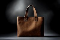 Brown leather tote bag with handles on dark background. Luxury handbag accessory for fashion, shopping and business use. Elegant women's purse design.